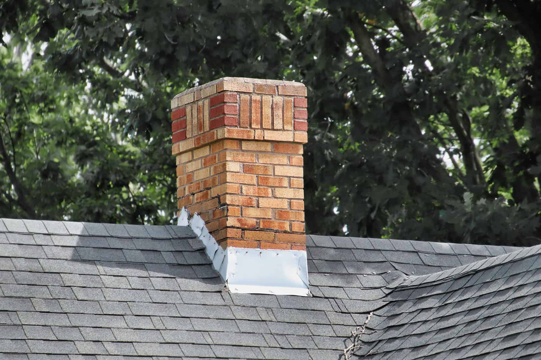 Professional roofer installing shingles